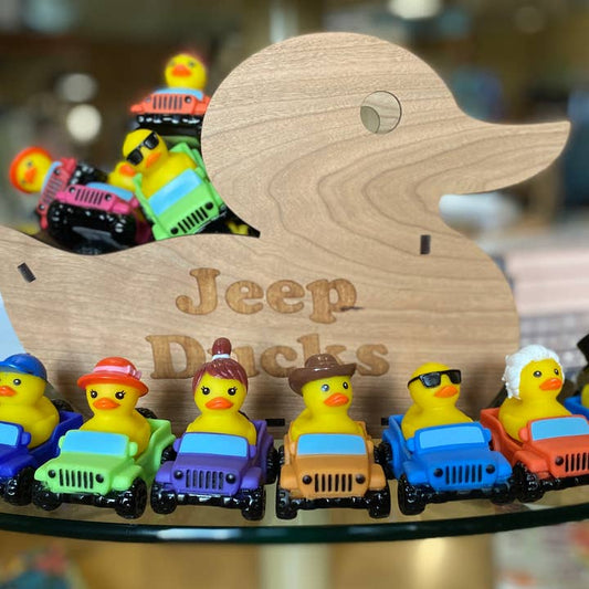 Off-road rubber duck riding in a small rubber Jeep-style vehicle